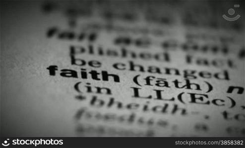 Definition of the word faith in a dictionary, close up view
