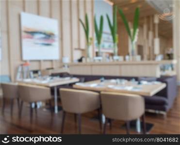 Defocus of modern restaurant of hotel with wooden furniture