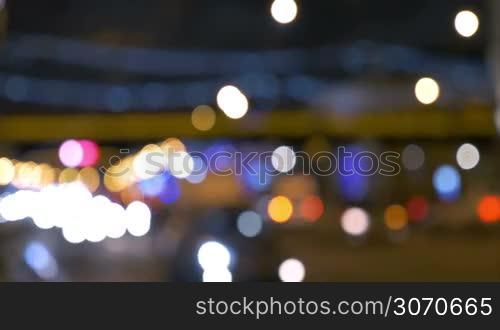 Defocus of road traffic at night. Blurrred lights of city and car head lamps