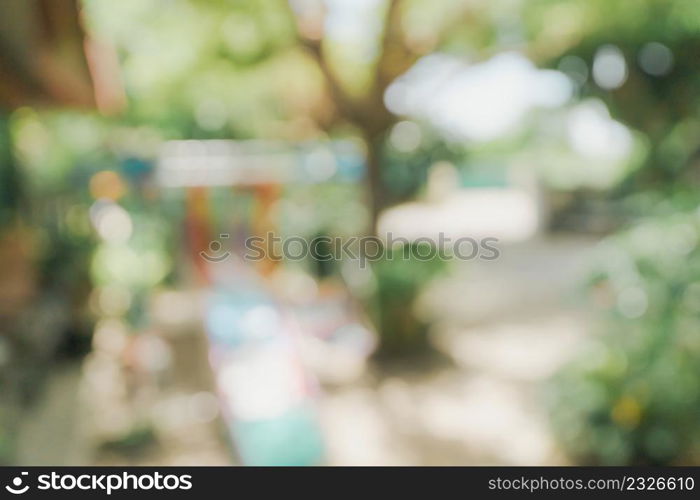 defocused bokeh and blur background of garden trees in sunlight.