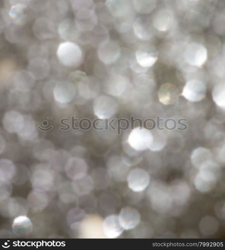 Defocused Bokeh twinkling lights Vintage background. Festive background with natural bokeh and bright golden lights.