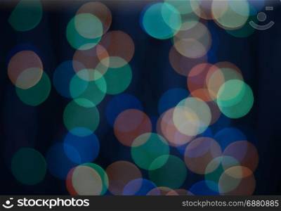 Defocused colored lights on the black background. Multicolored bokeh