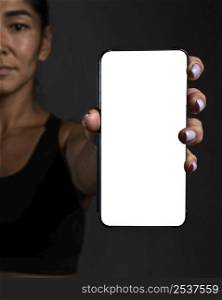 defocused female rugby player holding smartphone