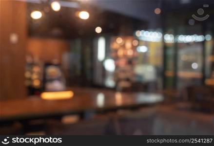 Defocused image of shop or cafe with bokeh coloful night lights background