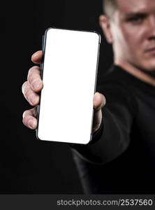 defocused male rugby player holding smartphone
