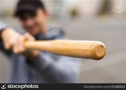 defocused man holding baseball bat