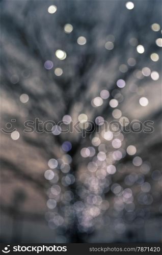 Defocused night lights on a deciduous tree, retro and vintage style image