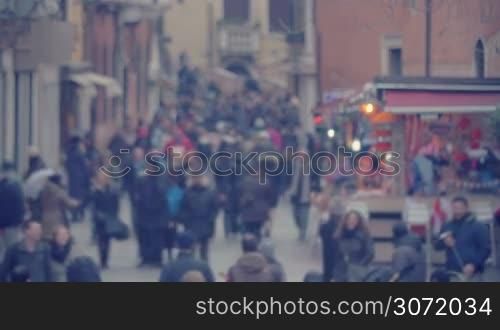 Defocused shot of crowded pedestrian street of Venice, Italy.