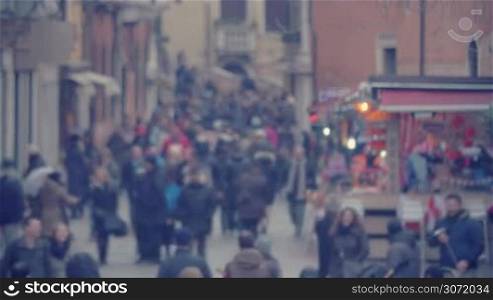 Defocused shot of crowded pedestrian street of Venice, Italy.