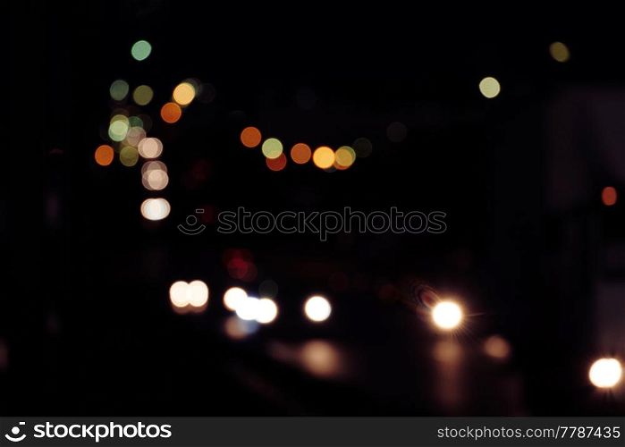 Defocused traffic lights in vintage color, nightlife background. Blurred de focused traffic lights in vintage color