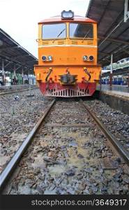 Deisel Engine of Red orange train, Diesel locomotive, on Bangkok railway station platform Thailand