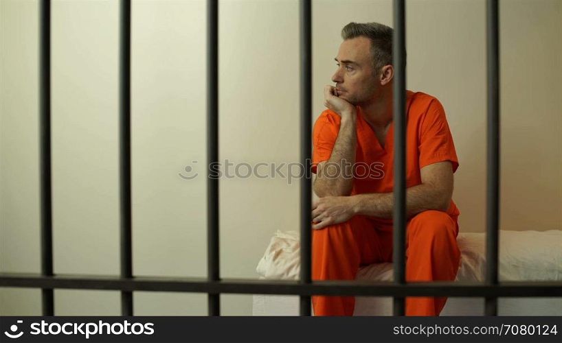 Dejeacted inmate sits behind bars in prison