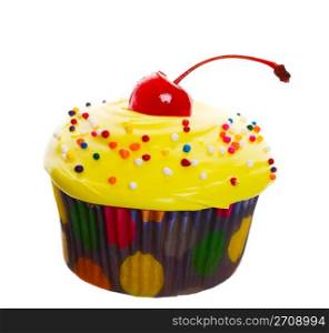 Delectable yellow cupcake topped with a cherry and multi-colored sprinkles. Shot on white background.