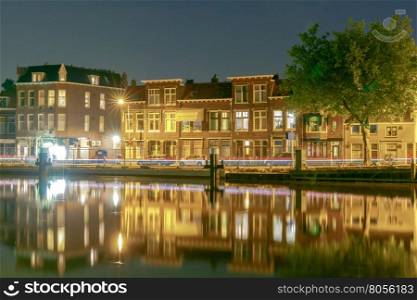 Delft. City Canal at night.. City quay with traditional Dutch houses at night. Delft. Netherlands.