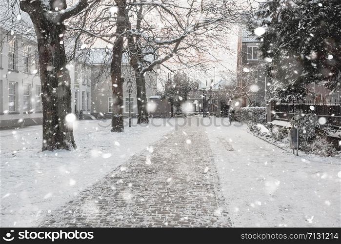 Delft Netherlands old yard view in residential district in winter snowstorm. Pastel trendy toning. Beautiful inspiring moody faded scenery