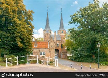 Delft. Old City Gates.. The old medieval city gate with two stone towers and bridge in Delft. Netherlands