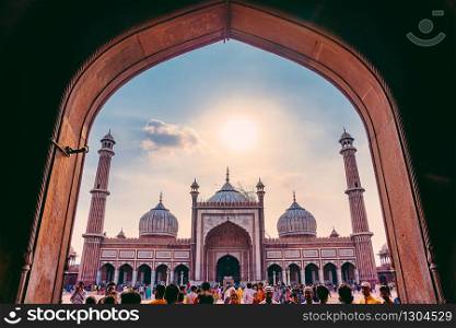 DELHI, INDIA - APRIL 19, 2019: Silhouette of visitors at doorway at Jama Masjid, Old Delhi, India