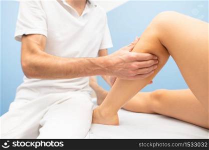 Delicate calf massage in a professional physiotherapist&rsquo;s studio.