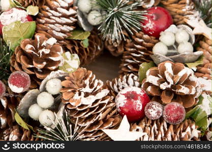 Delicate Christmas wreath of pine cones on gray wooden background