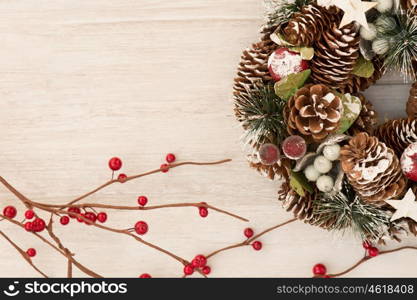 Delicate Christmas wreath of pine cones on gray wooden background