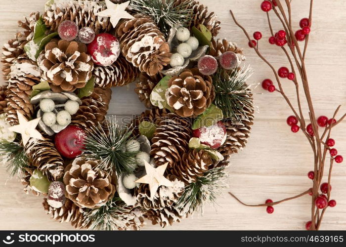 Delicate Christmas wreath of pine cones on gray wooden background