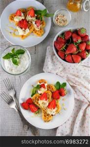 Delicate, melting mouth-watering Belgian waffles with whipped cream, strawberries, flavored with peanuts and honey. What could be better for breakfast.