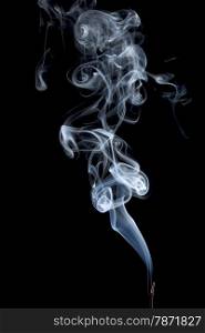 delicate smoke plume from a burning incense stick