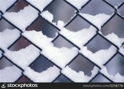Delicate Snow Patterns in Chain Link Fence