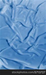 delicate waves of blue satin silk close up