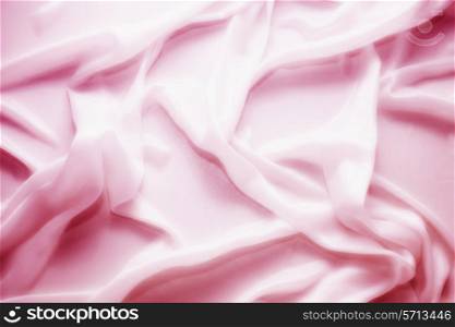 delicate waves of pink satin silk close up