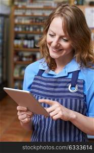 Delicatessen Owner In Store With Digital Tablet