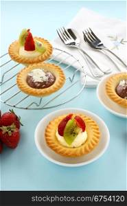 Delicious and decadent cream and chocolate tarts with fresh strawberries.