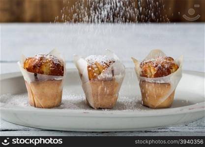 Delicious and fluffy homemade muffins yogurt sprinkled with icing sugar