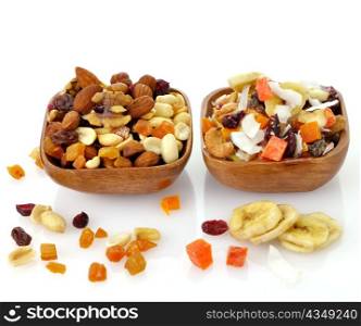 Delicious and healthy mixed dried fruit, nuts and seeds in the wooden bowls