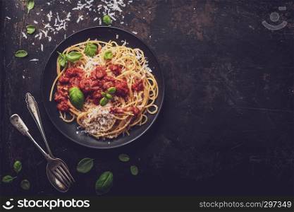 delicious appetizing classic spaghetti pasta with tomato sauce, parmesan cheese and fresh basil, top view