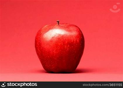 delicious apple on red background