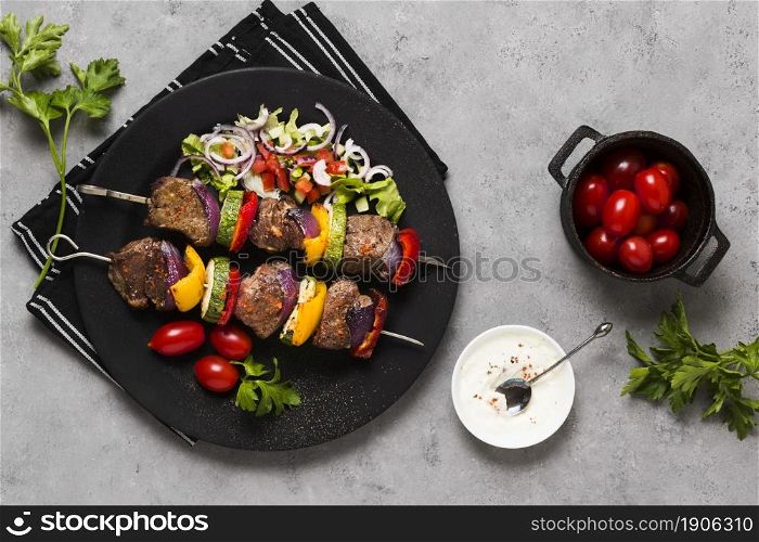 delicious arabic fast food skewers black plate tomatoes. High resolution photo. delicious arabic fast food skewers black plate tomatoes. High quality photo