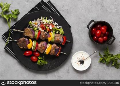 delicious arabic fast food skewers black plate tomatoes. High resolution photo. delicious arabic fast food skewers black plate tomatoes. High quality photo