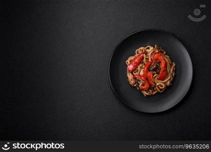 Delicious asian udon dish with vegetables, mushrooms, salt and spices on a ceramic plate on a dark concrete background