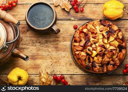Delicious autumn quince pie. Autumn sweet on rustic wooden table. Fruit pie with apple