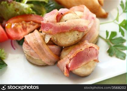 Delicious bacon wrapped mushrooms served with a fresh garden salad.