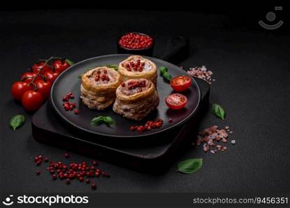 Delicious baked meat roll wrapped in bacon with salt, spices and herbs on a dark concrete background
