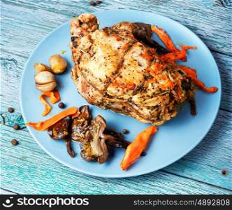 Delicious baked meat, stuffed with mushrooms. Baked meat grill with mushrooms on a wooden background