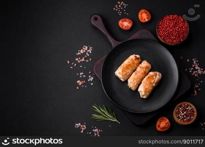 Delicious baked pork or chicken roll with mushrooms, spices and herbs inside on a dark concrete background