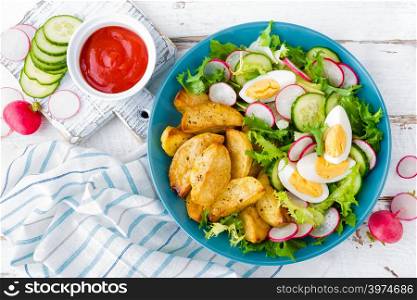 Delicious baked potato, boiled egg and fresh vegetable salad of lettuce, cucumber and radish. Summer menu for detox diet