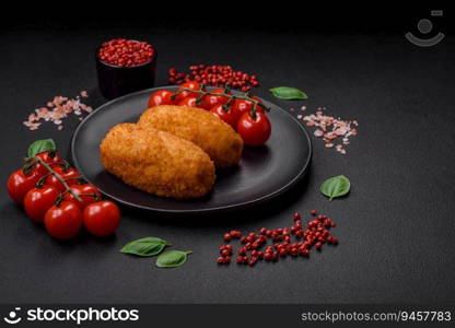 Delicious baked potato cutlet stuffed with chicken and vegetables, spices and salt on a dark concrete background