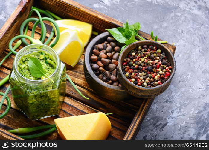 Delicious basil pesto sauce. Pesto sauce in bowl with pine nuts, parmesan and garlic