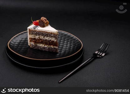 Delicious beautiful piece of cake with cream and berries on a black ceramic plate on a dark concrete background