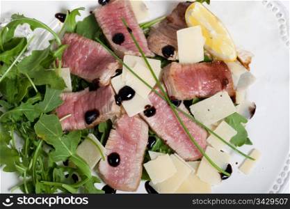 Delicious beef on arugula salad and parmesan