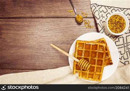 delicious belgian waffle with honey bee pollen wooden desk